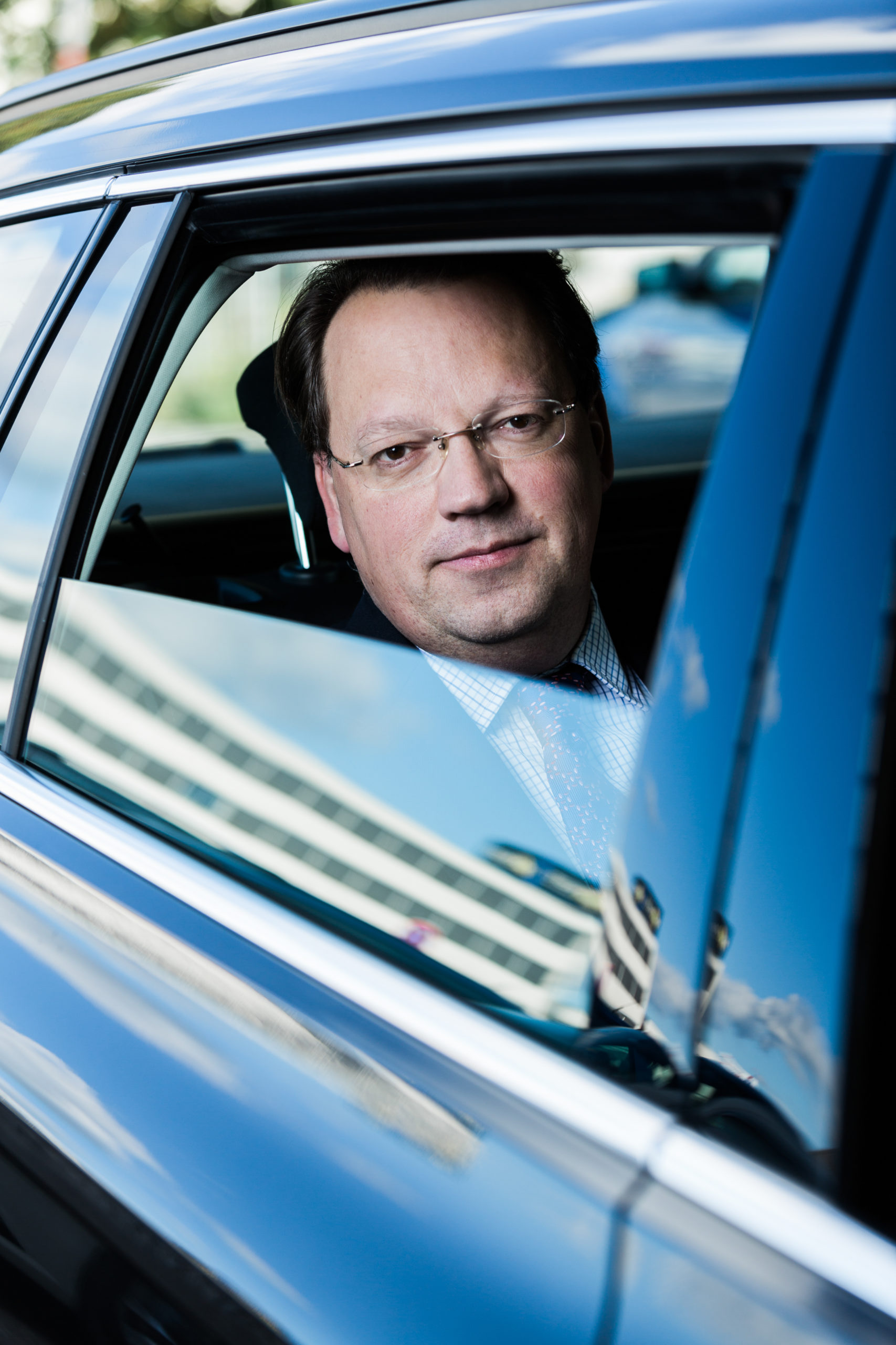 Corporate portrait of a guy in a car